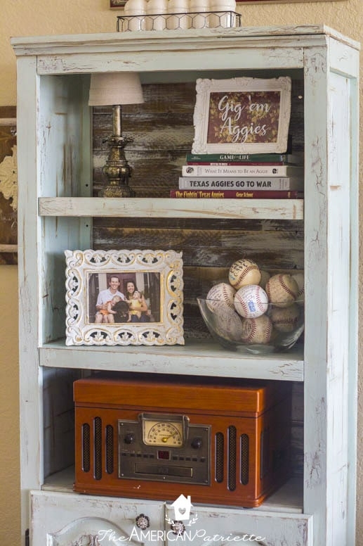 Bookshelf with Teal Finish, Distressed Edges, and Woven Baskets