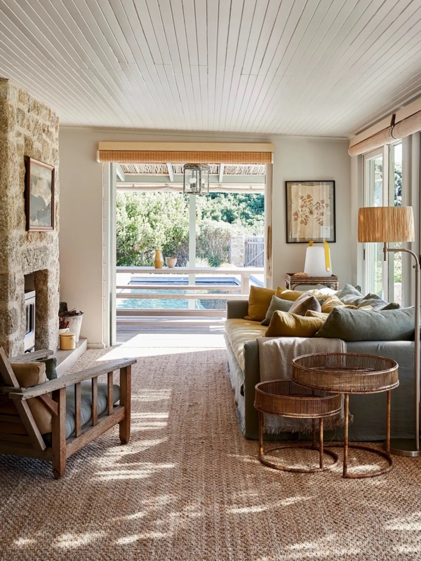 Coastal Living Room Ideas featuring Stone Fireplace and Woven Jute Rug.