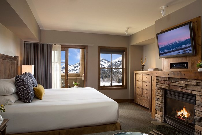 Cozy Lodge Bedroom with Stone Fireplace and Wood Furniture