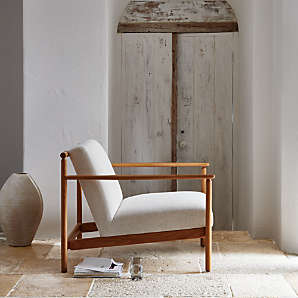 Curved Back Accent Chair: Barrel Silhouette with Textured White Upholstery.