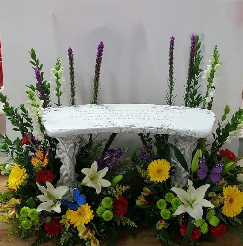 Memorial Bench with Engraved Text and Floral Surround