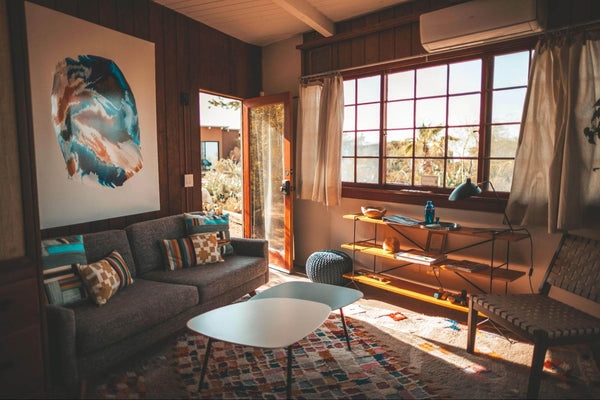 Mid-Century Living Room with Wood Paneling and Large Grid Window Layout