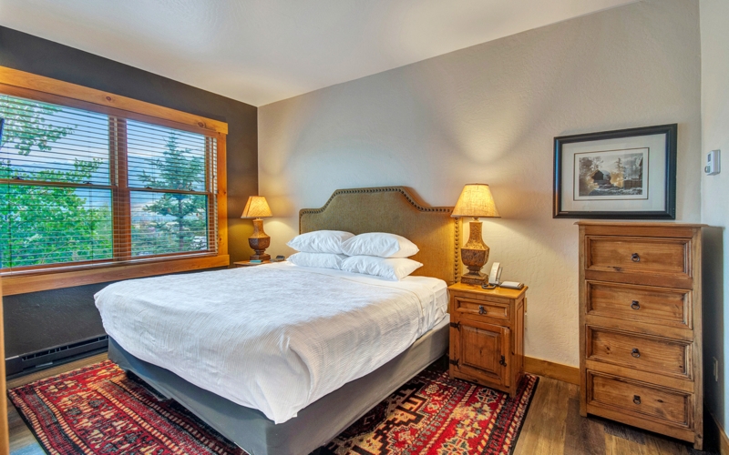 Upholstered Bed Rustic Styling against Log Walls