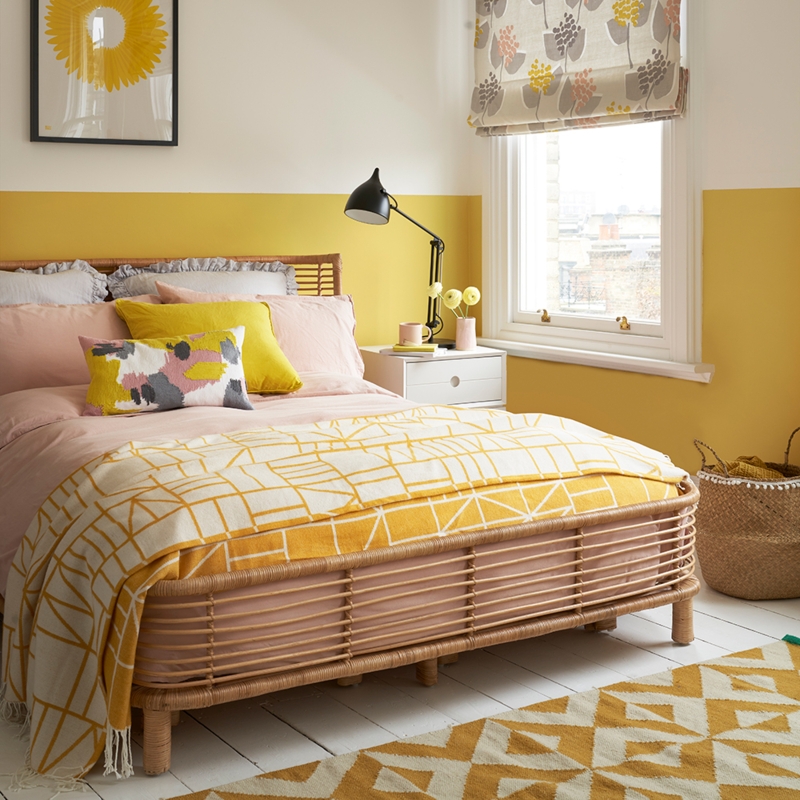 Bed with Vibrant Yellow Palette against White Shiplap Accent Wall