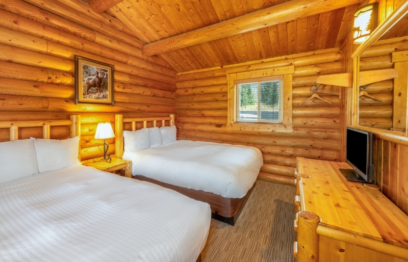 Cabin Bedroom Log Walls Red Accents Symmetrical Twin Beds