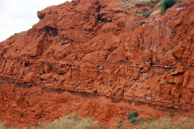 Deep Terracotta Stratified Rock with Exposed Earth Landscape