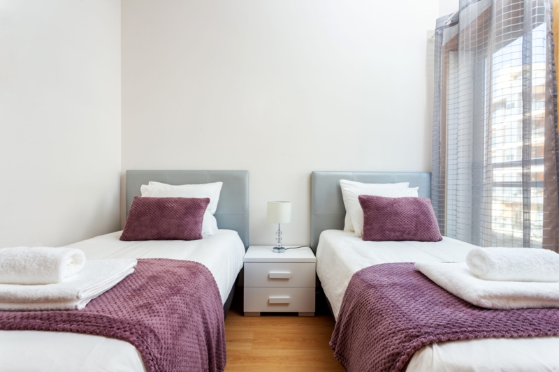 Mattress Comparison Display on a Minimalist Wood Platform Bed Frame.