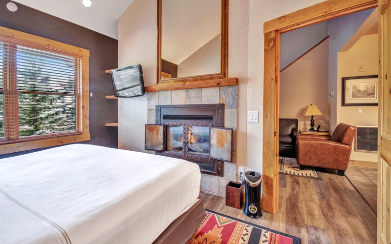 Rustic Bedroom Timber Truss Ceiling Stone Corner Fireplace Vaulted