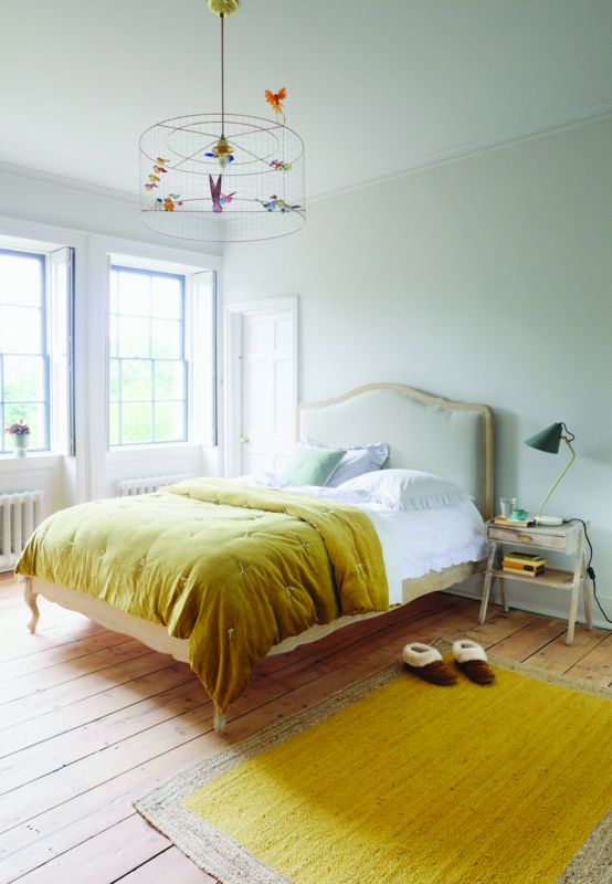 Saturated Yellow Bedding against Clean White Walls
