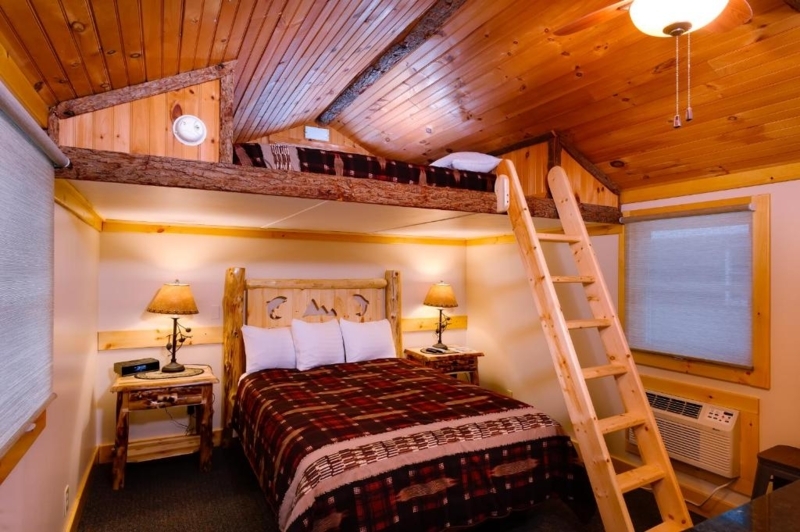 Wood Paneled Cabin Bedroom Antler Chandelier Plaid Patchwork Quilt