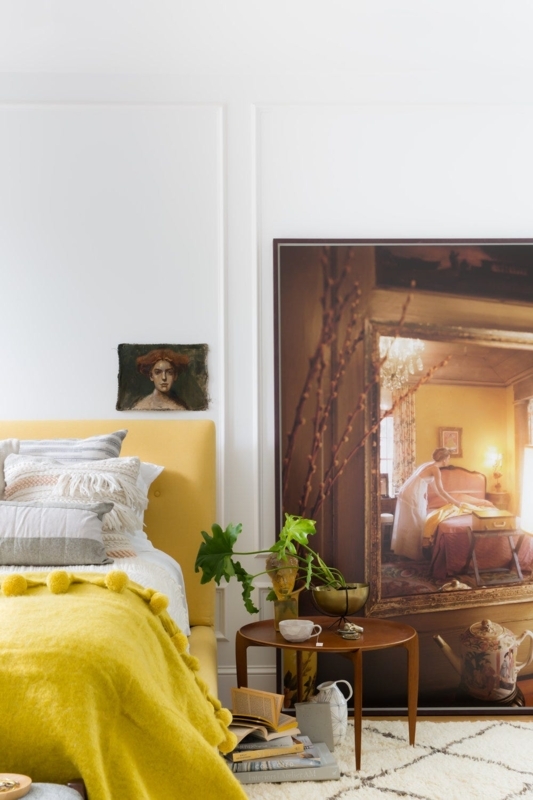 Yellow Bedding against White Wainscoting and Patterned Walls