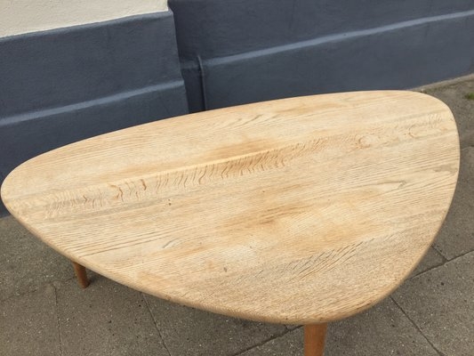 Coffee Table Featuring Tapered Tripod Legs and Rounded Top