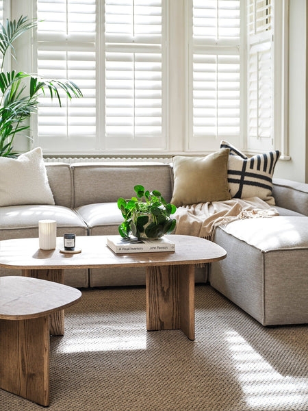 Coffee Table in Light Wood Tone with Tapered Legs and Rounded Edges