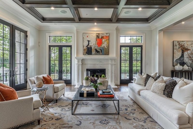 Cream Sectional Sofa With Arched Window Backdrop and Wall Paneling