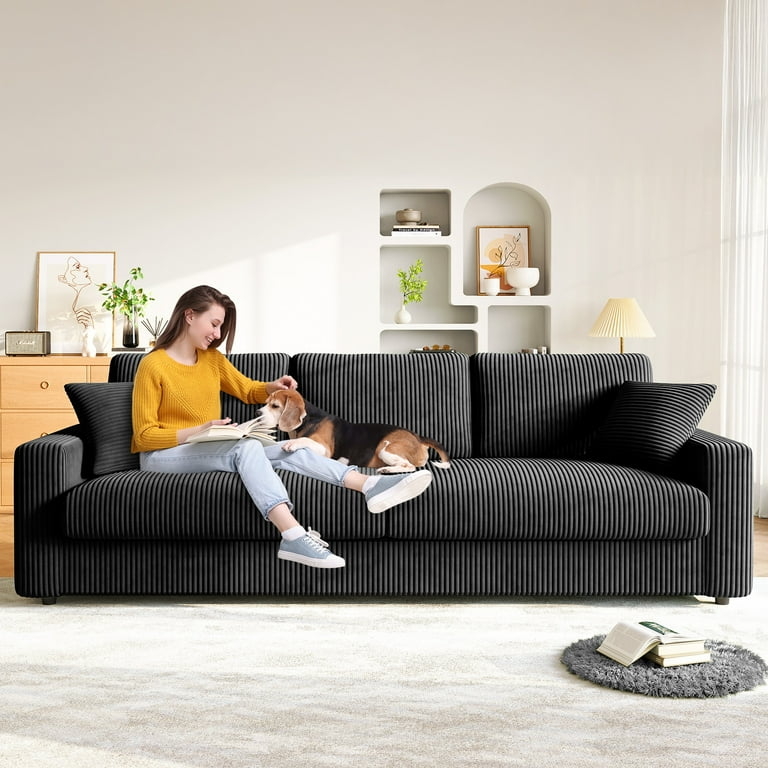 Deep Seat Sofa Featuring Wide Arms And Matte Black Corduroy Finish.