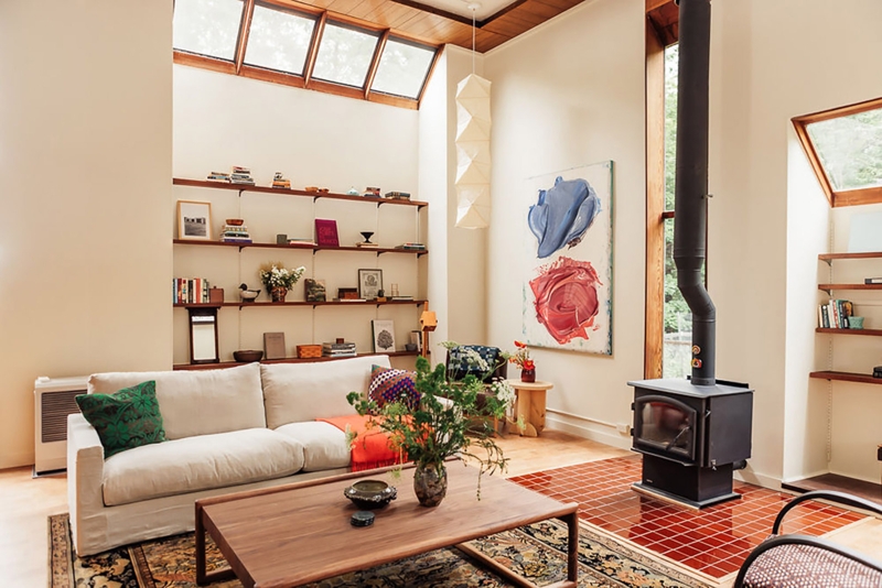 Exposed Wood Frame Sofa with Integrated Bookcase in Airy Living Room