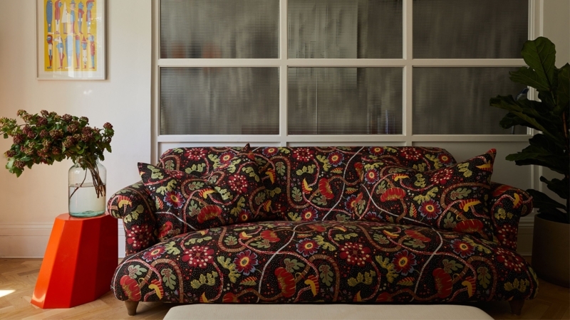 Geometric Patterned Sofa against Blue Paneled Walls