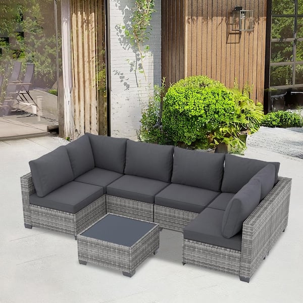 Gray Wicker Outdoor Sectional Set with Glass-Top Coffee Table.