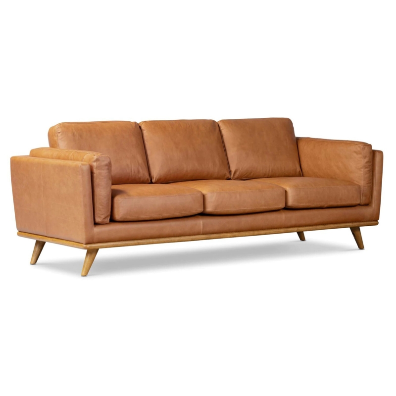 Minimalist Cognac Sofa Blocky Silhouette Stone Fireplace Setting