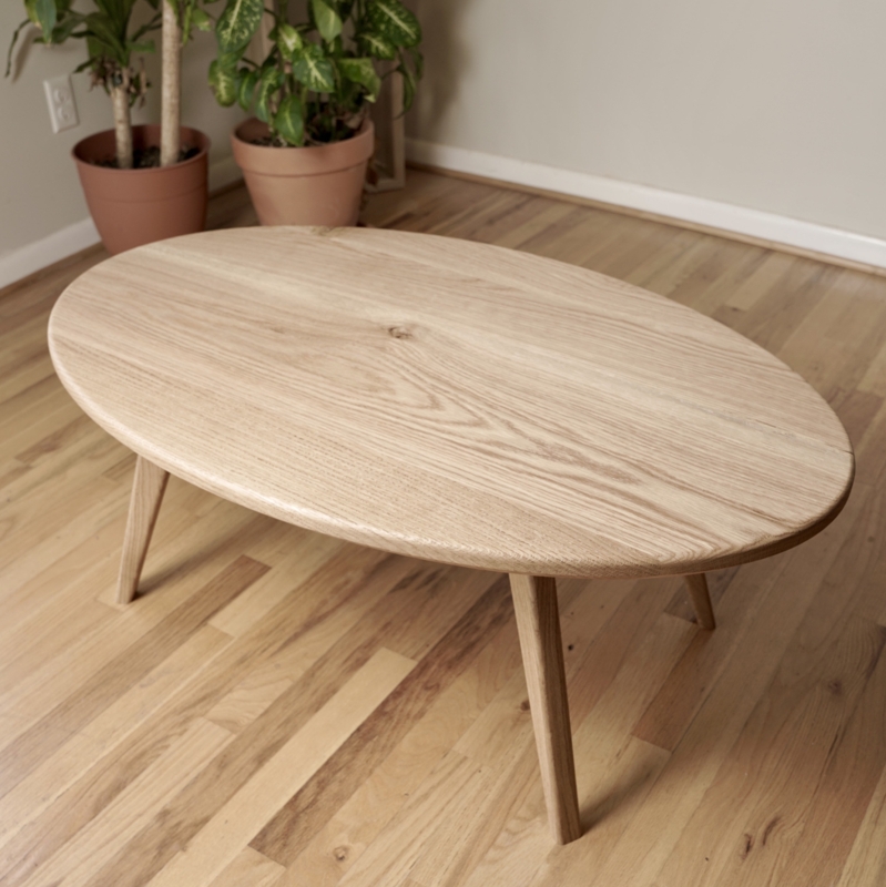 Oval Coffee Table with Splayed Tapered Legs and Beveled Edge