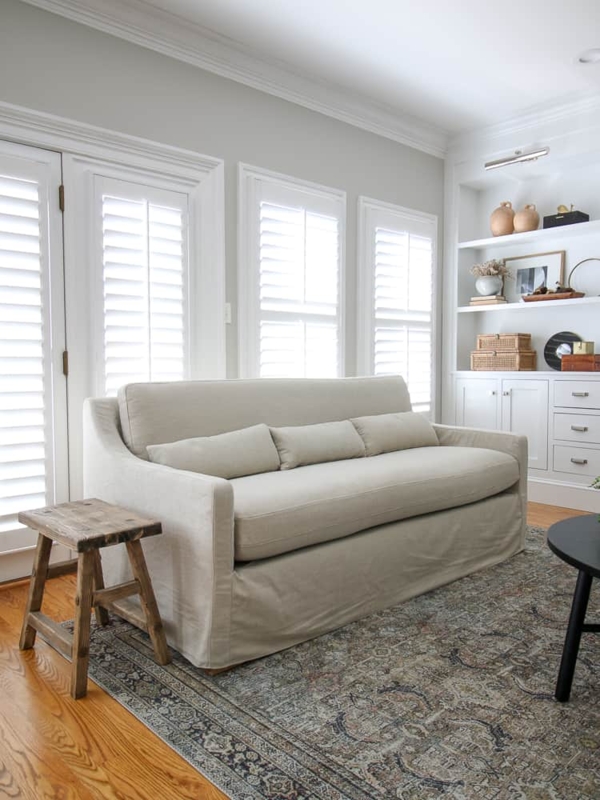 Sofa Cream Bench Seat with Tapered Wood Legs and Arched Doorway View