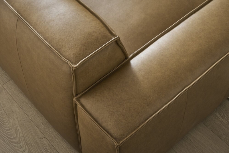 Sofa Detail featuring Tufted Seat and Bolster Pillow Caramel Finish