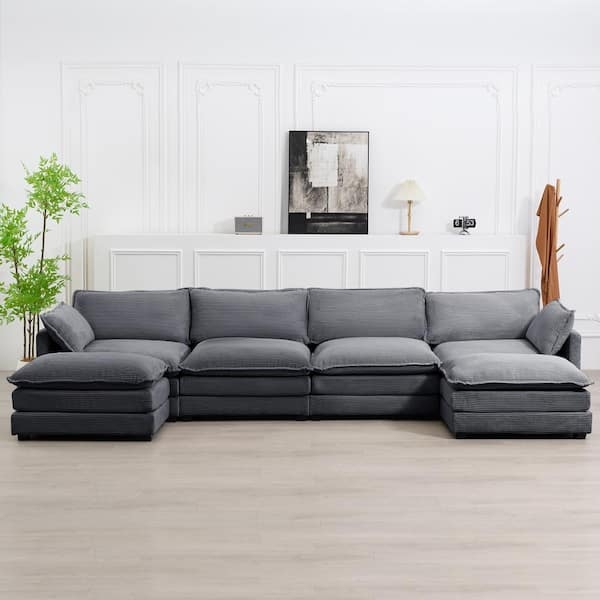 Spacious U-Shaped Sectional Sofa with Matching Ottoman and Dark Grey Fabric.