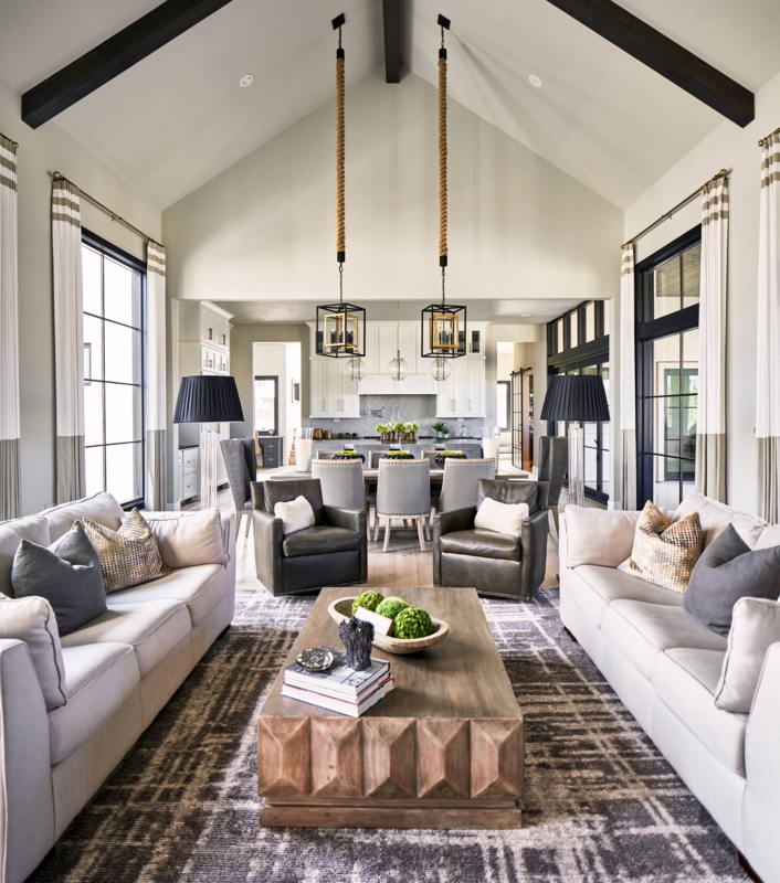 Symmetrical Living Room with Navy Sofas and Tufted Ottoman Coffee Table