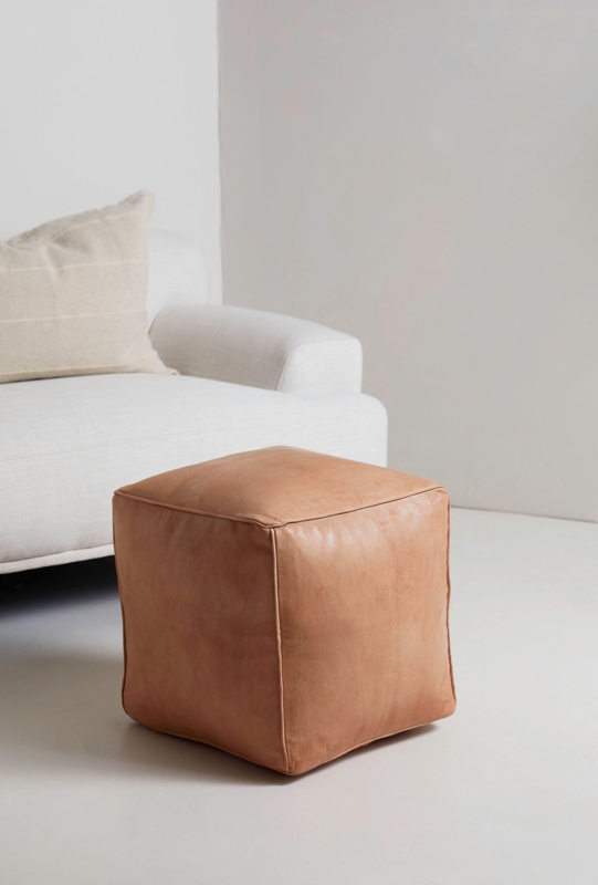Tan Leather-Like Pouf featuring Piping Detail and Visible Stitching