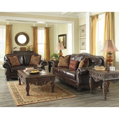 Traditional Brown Living Room Set with Ornate Floral Carvings.