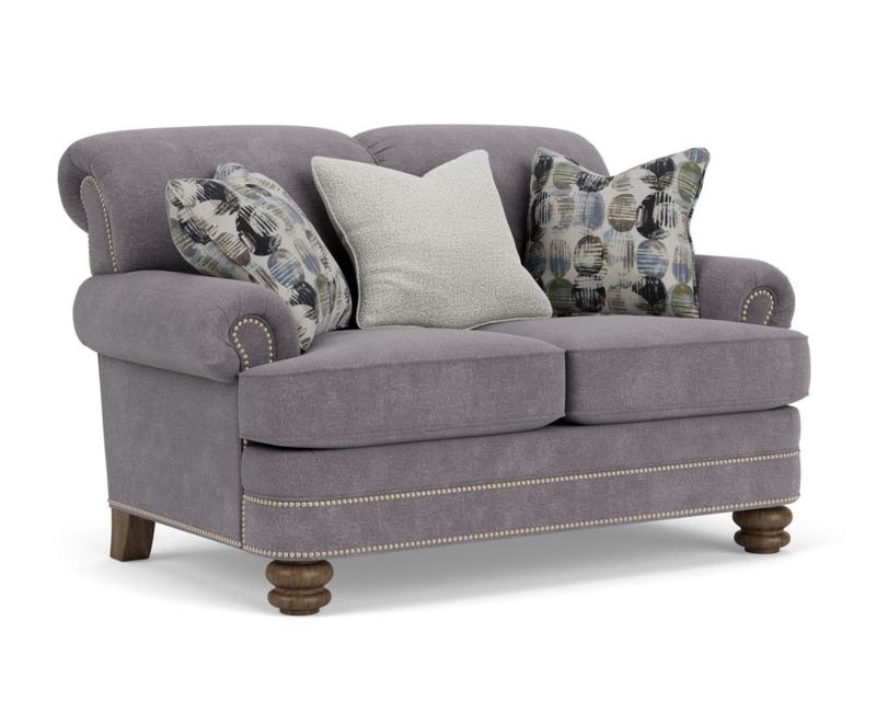 Beige Upholstered Loveseat with Rolled Arms and Patterned Pillows