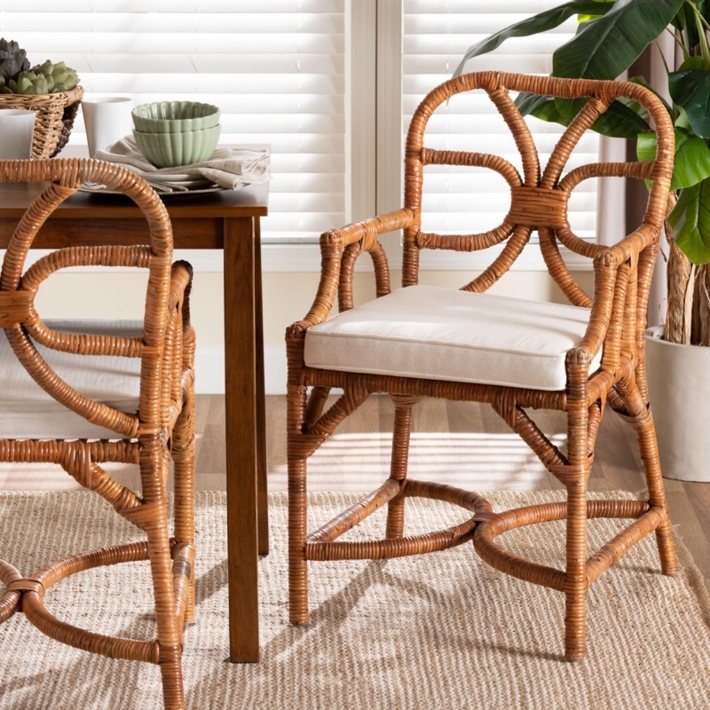 Dining Chair: Handcrafted Rattan with Curved Arm Silhouette.