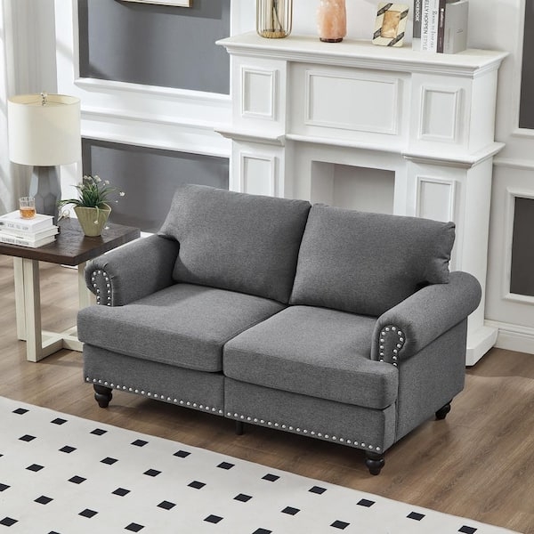 Gray Upholstered Loveseat with Spindle Legs and Nailhead Trim
