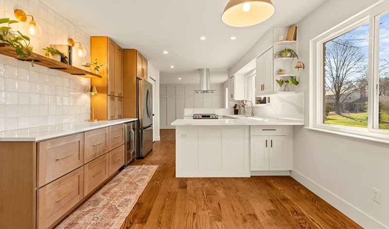 Kitchen Cabinets in Natural Wood with Contrasting Dark Island Layout