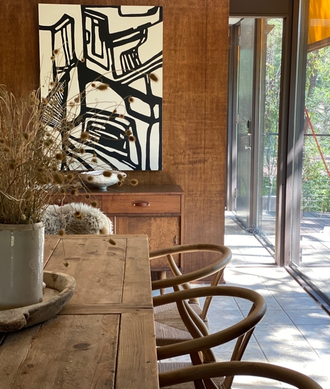 Light Wood Wishbone Chair in Airy Organic Dining Room with Curtains.