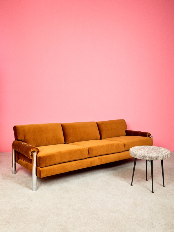 Minimalist Three-Seater Sofa in Dark Gray with Continuous Chrome Frame.