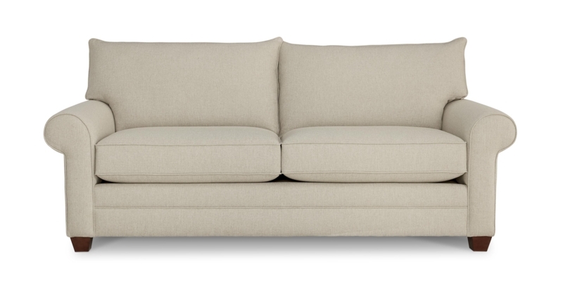 Sectional Sofa in Cream Fabric with Rolled Arms and Loose Back Cushions
