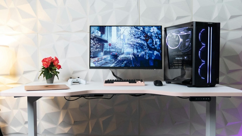 All-White L-Shaped Gaming Desk Setup with Slat Wall Backdrop
