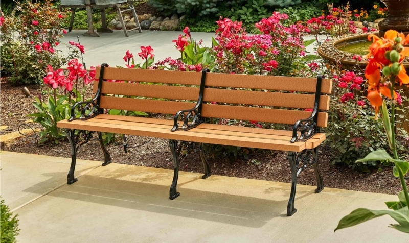 Backless Park Bench. Modern sculptural metal legs, wood-toned slatted seat.