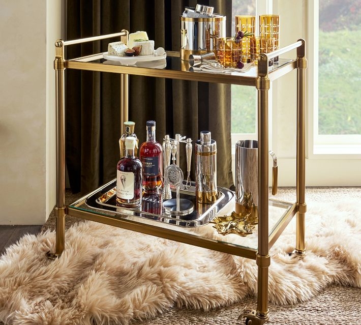 Bar Cart in Antique Brass with Oversized Spoke Wheels and Mirrored Glass.