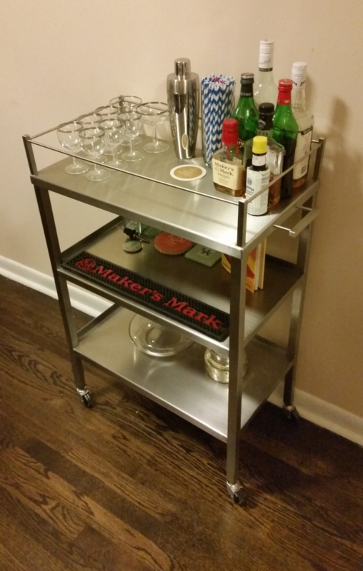 Bar Cart Stainless Steel Tubular Frame Minimalist Design Integrated Handles.