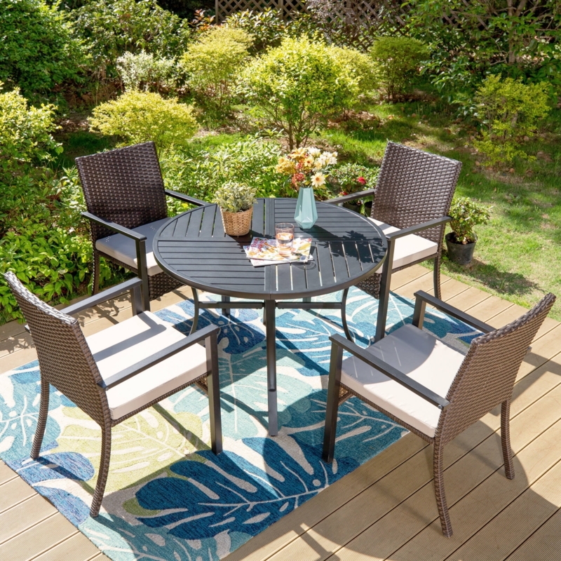 Black Wicker Patio Dining Set: Round Wood-Toned Table, Beige Cushions.