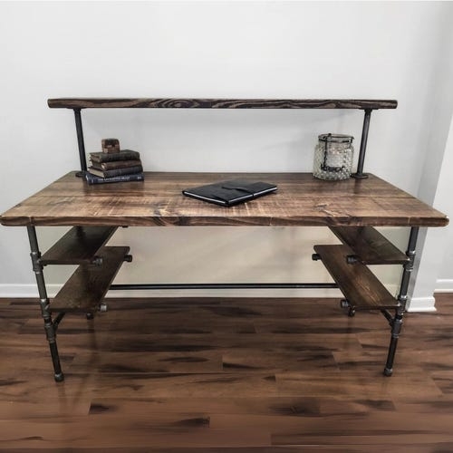 L-Shaped Desk with Pipe Fittings and Integrated Monitor Riser Shelf.