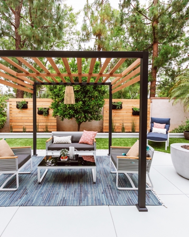 Outdoor Sectional with Black Metal Chairs and Geometric Rug