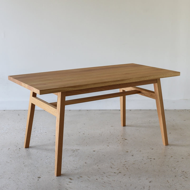 Writing Desk featuring Angled Tapered Legs and Light Wood Finish.