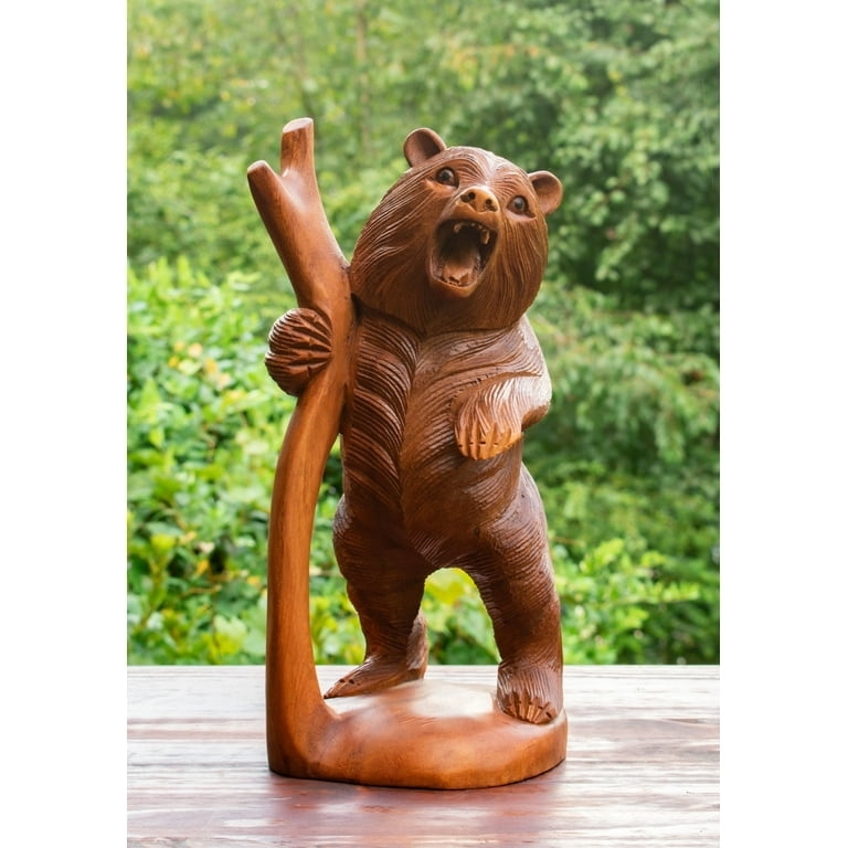 Bear Figurine with a hand carved look inside a hollowed tree form.