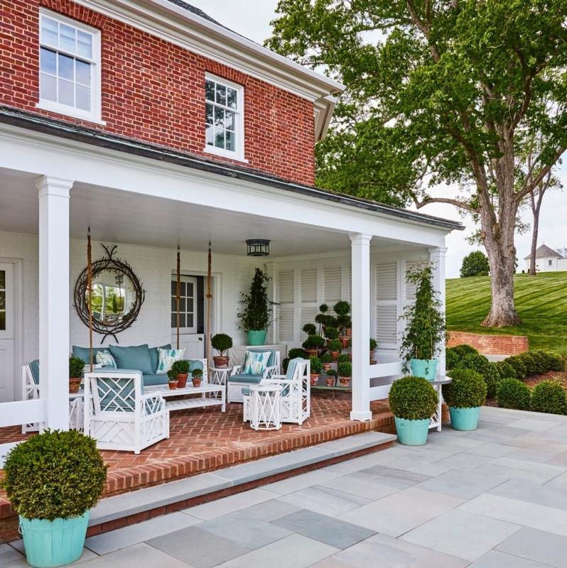 Blue and White Outdoor Sofa Set with Wicker Accents on Porch