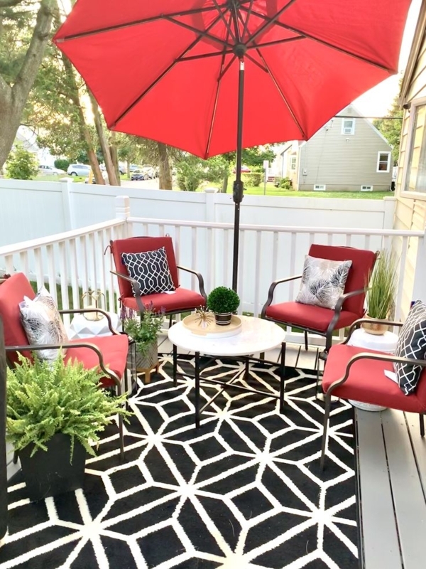 Bold Red and Black Patio with Striped Privacy Screen and Graphic Rug