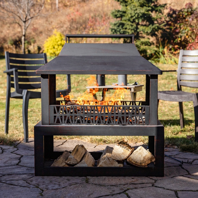 Bronze Outdoor Fireplace with Integrated Storage on Rustic Stone Patio