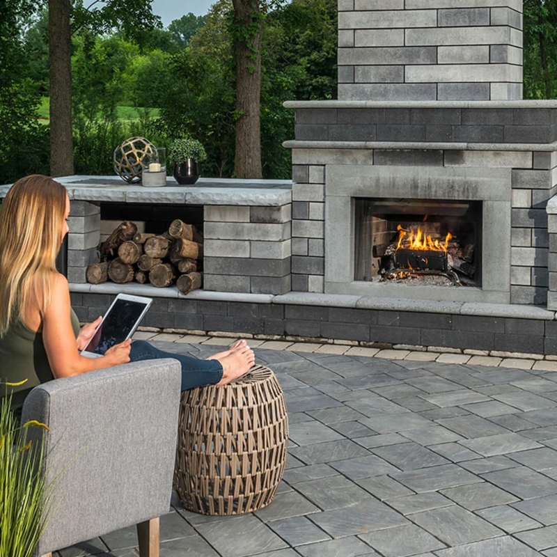 Built-In Outdoor Fireplace, Stacked Stone Masonry, Integrated Lighting.
